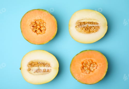 Preview: Tasty colorful ripe melons on light blue background, flat lay