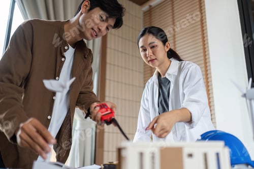 Preview: ESG Focused Teamwork. Architects collaborating on a sustainable model project.