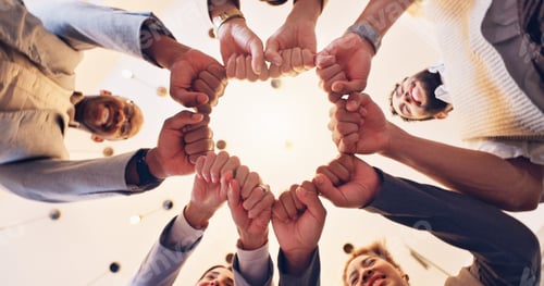Preview: Happy, business people or meeting with fist bump below for unity, motivation or teamwork at office.