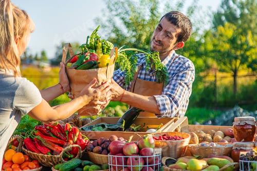 Preview: Man and woman at a farmers market. Selective focus.