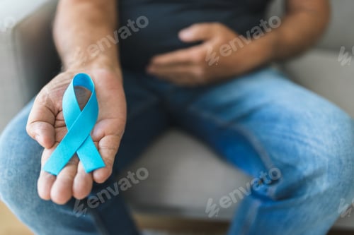 Preview: Senior man holding a blue cancer awareness ribbon