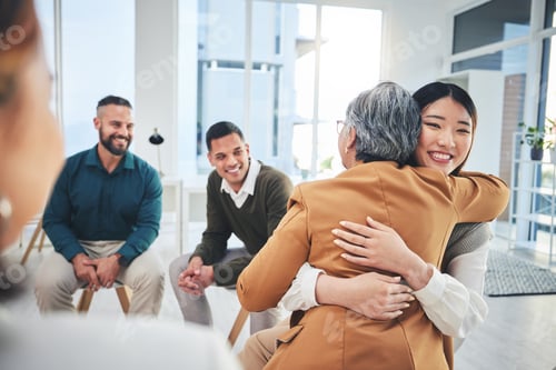 Preview: Business people, women and hug in group therapy with care, love and bonding for mental health in wo