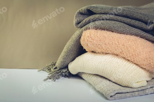 Preview: Stack of cozy knitted sweaters