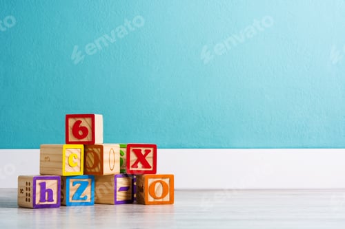 Preview: Colorful wooden alphabet blocks forming a stack on floor