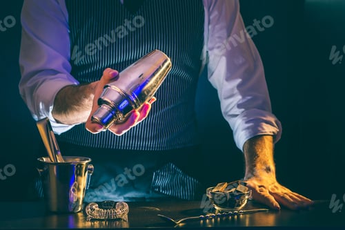 Preview: Bartender making cocktail, using cocktail shaker