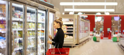 Preview: Woman Choosing Frozen Food From A Supermarket Freezer