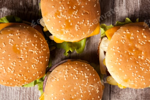 Preview: Delicious tasty burgers on wooden background