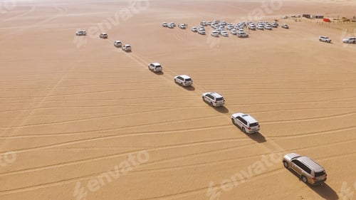 Preview: 4x4 SUVs cars driving through the sand dunes in the desert of Abu Dhabi. Stock. Top view on SUVs in