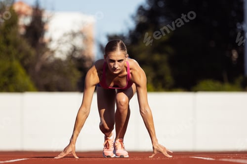 Preview: At start line. One Caucasian woman, female athlete, runner training at public stadium, sport court