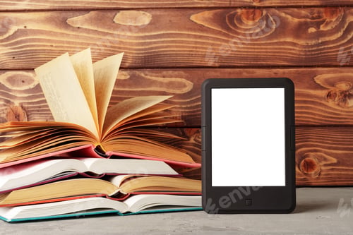 Preview: Digital tablet and stack of hardcover books against wooden background