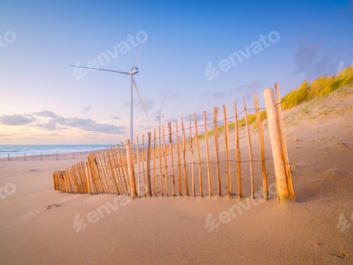 Preview: Wind turbines on the seashore during sunset. Renewable energy sources. Netherlands.
