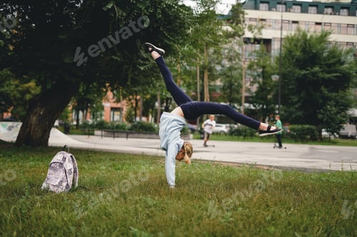 Preview: Young school girl doing handsring outdoor