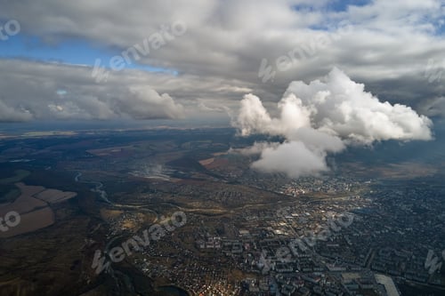 Preview: Aerial view from airplane window at high altitude of distant city