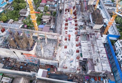 Preview: Aerial view of busy industrial construction site workers working. Development high rise building.