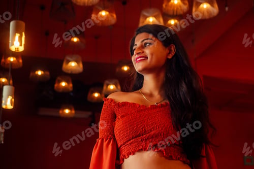 Preview: india girl long hair in red blouse stang lighting diyas in dark room