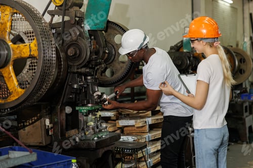 professional engineer team inspecting service machine in heavy industry factory
