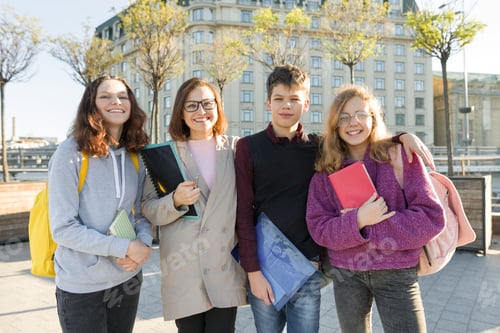 Preview: Group of students with teacher, teenagers talking to a female teacher