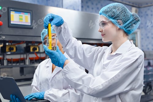 Preview: Bottling factory worker inspecting quality of water bottles before shipment. Reverse osmosis system