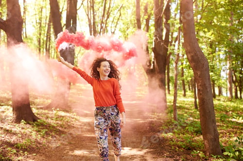 Preview: young woman hipster running in forest with pink smoke grenade
