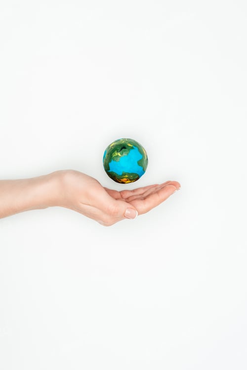 Preview: cropped image of woman holding hand near earth model isolated on white, earth day concept
