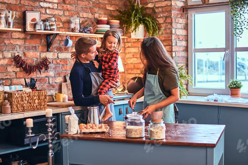 Preview: Family together cooking breakfast in loft style kitchen.