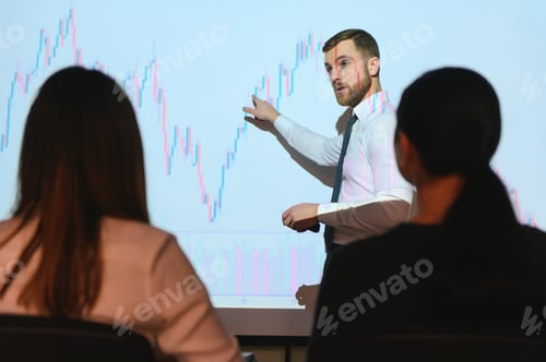 Preview: Man is standing near projector and showing graphs and business graphs.
