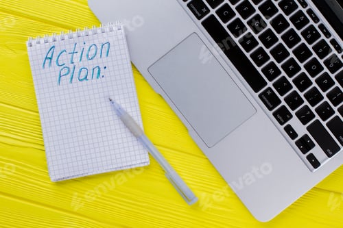 Preview: Notepad with action plan and laptop pc.