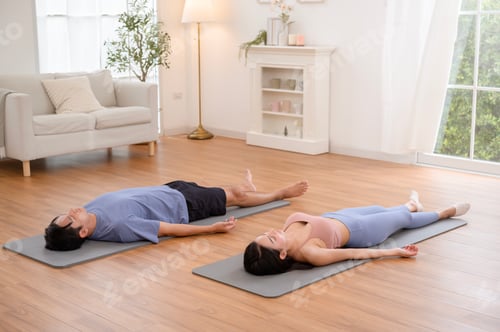 Preview: Couple Practicing Relaxation and Mindfulness Through Yoga in a Calm Indoor Setting