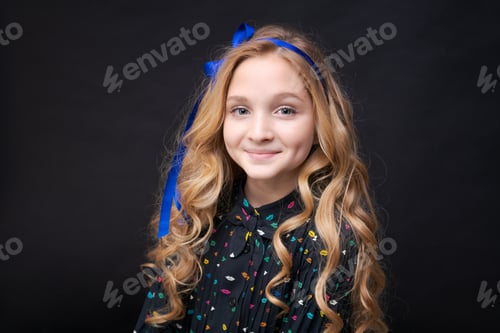 Preview: Smiling pretty little caucasian girl 12-10 posing on black background