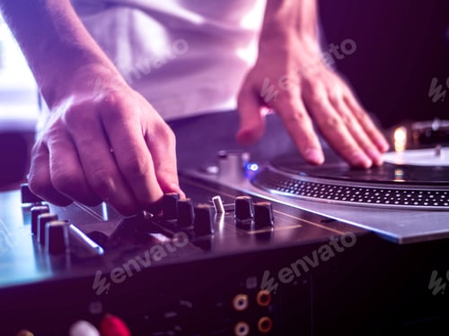 Preview: close up young dj playing modern music on professional equipment setup toned