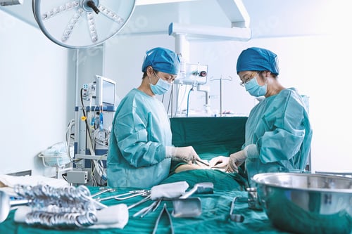 Preview: Surgeons performing surgery on patient abdomen in maternity ward operating theatre
