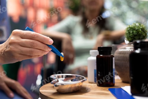 Preview: Professional nurse separating pills and medicine in two different bottles