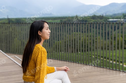 Preview: Woman sit at outdoor and enjoy the scenery view