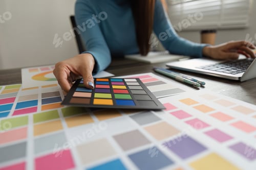 Preview: A professional designer evaluating color options using swatches in a stylish workspace.