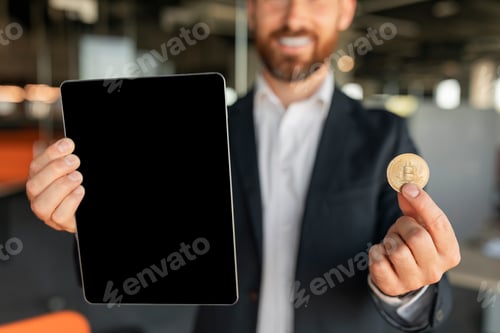 Preview: Happy businessman holding bitcoin and tablet with empty screen, recommending cryptocurrency app in