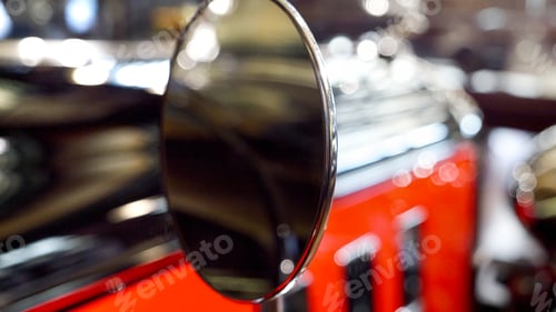 Preview: Macro shot of round back view mirror on vintage car painted in red and black