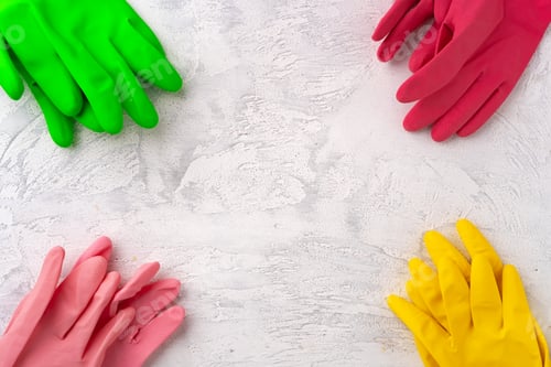 Preview: Four pairs of color rubber gloves on gray background