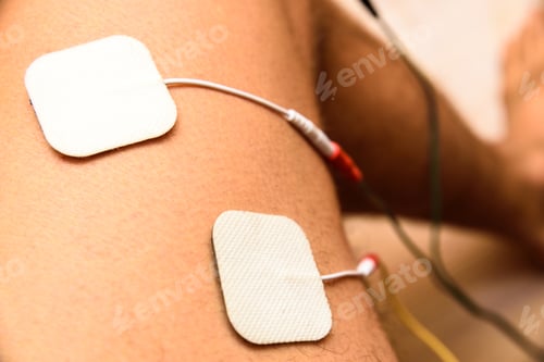 Preview: Injured athlete applies ems electrodes to his legs to recover muscle tone