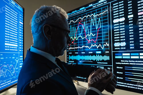 Preview: The businessman stands near the big digital screen in the dark office