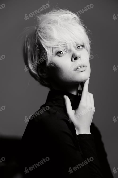 Preview: Stylish young woman with short blonde hair and a turtleneck, creating a striking monochrome portrait
