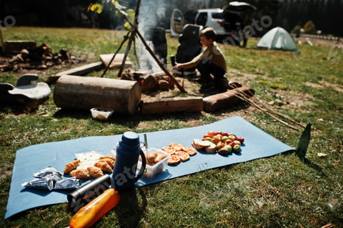 Preview: Family bonfire in mountain. Autumn hike and camp weather. Warming and cooking near flame together.