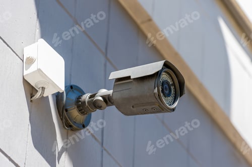 Preview: close up of security camera on wall, security system concept