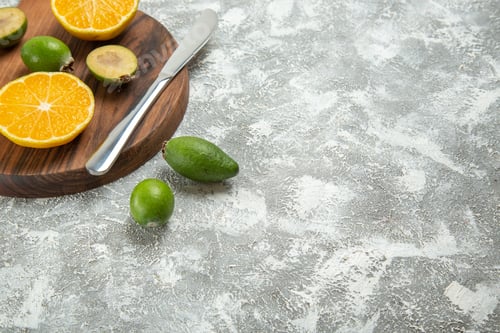 Preview: front view fresh sliced oranges with feijoa on the white background ripe fruit exotic tropical fresh