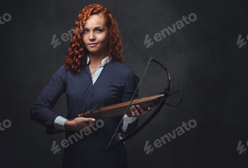 Preview: Redhead female holds crossbow.