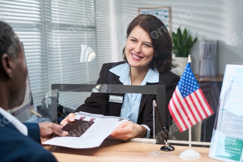 Preview: Middle Aged Woman Assisting Black Man with Visa Application Process