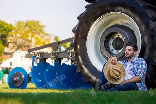 Preview: Farmer Relaxing Next to Agricultural Machinery