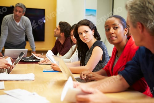 Preview: Male Boss Addressing Meeting Around Boardroom Table