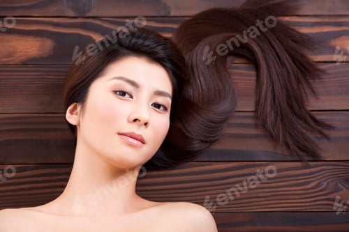 Preview: Charming young woman with silk-like hair