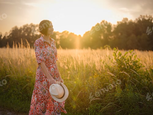 Preview: boho chic woman in a floral dress in European countryside