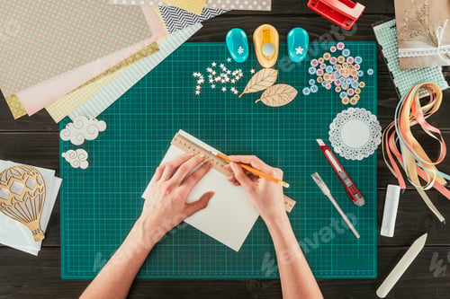 Preview: cropped image of woman measuring paper for scrapbooking postcard
